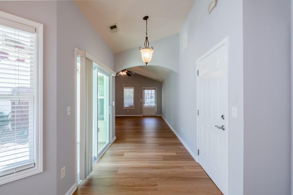 150 Jaime Drive Canton, GA 30114 - Photo 7 of 34 a view of a hallway to a livingroom with wooden floor and a window