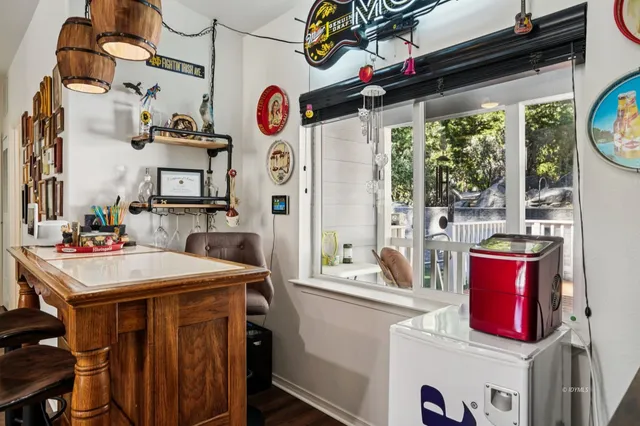 a kitchen with granite countertop stainless steel appliances a sink stove refrigerator and cabinets