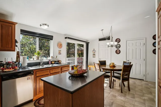 a dining room with furniture a chandelier and window