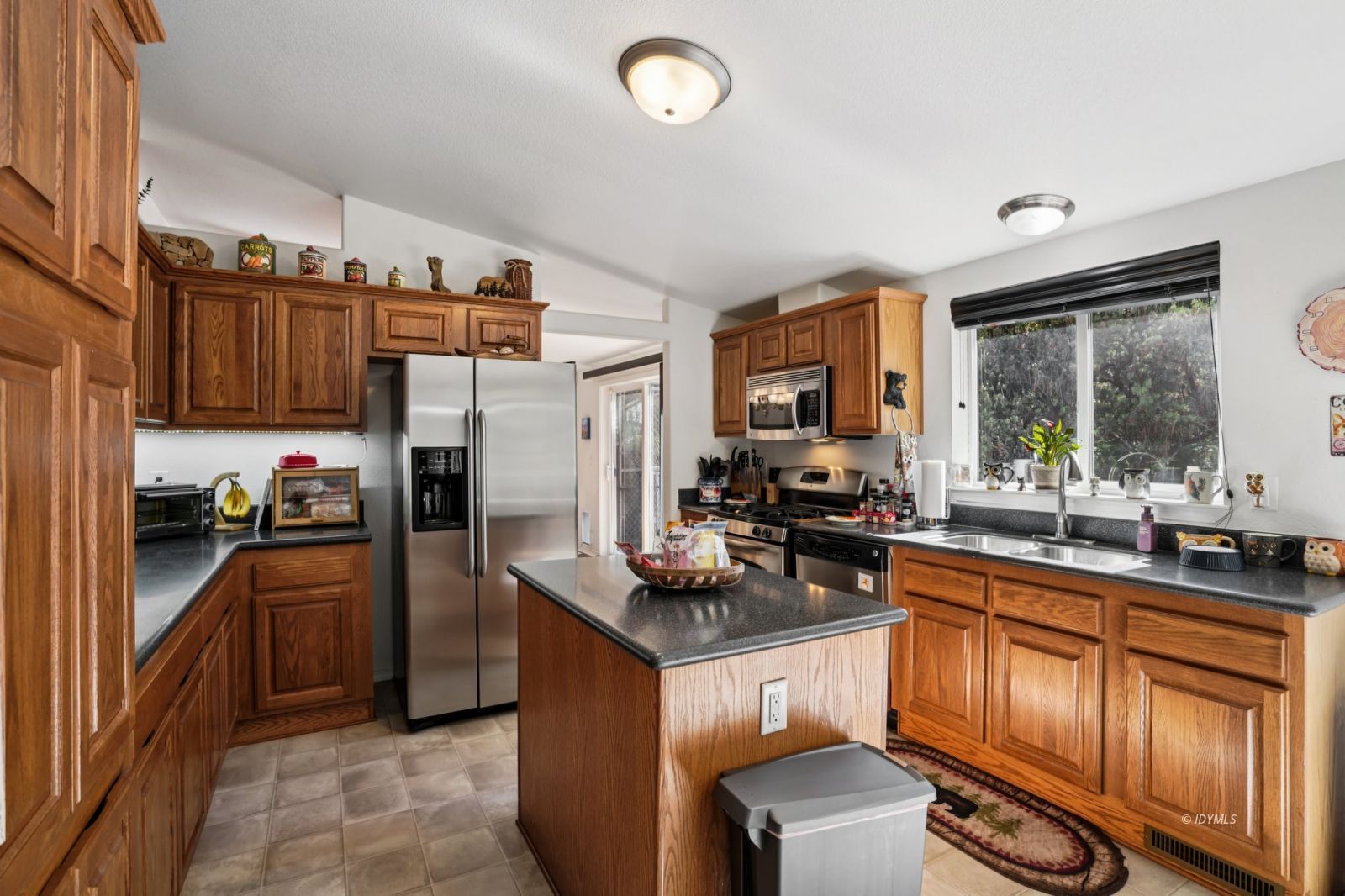 25001 Rim Rock Road Idyllwild, CA 92549 - Photo 19 of 50 a kitchen with granite countertop stainless steel appliances a sink stove refrigerator and cabinets