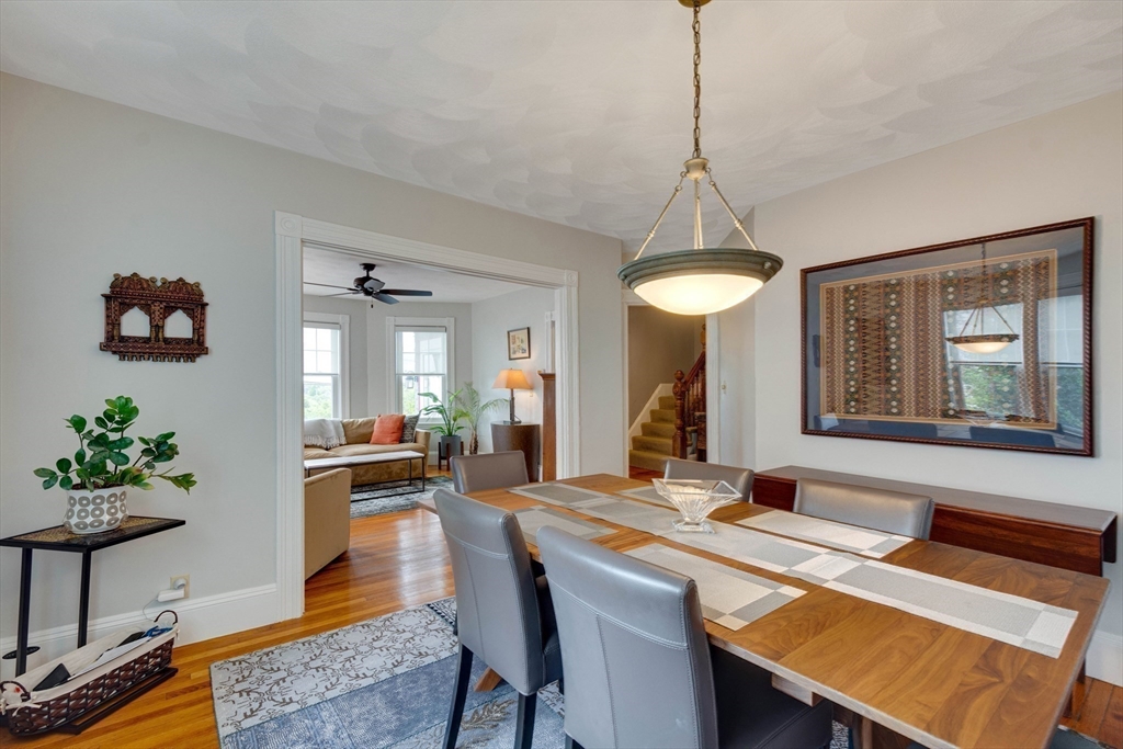 2 Deane Avenue Winthrop, MA 02152 - Photo 14 of 42 a dining room with wooden floor a chandelier a wooden table and chairs