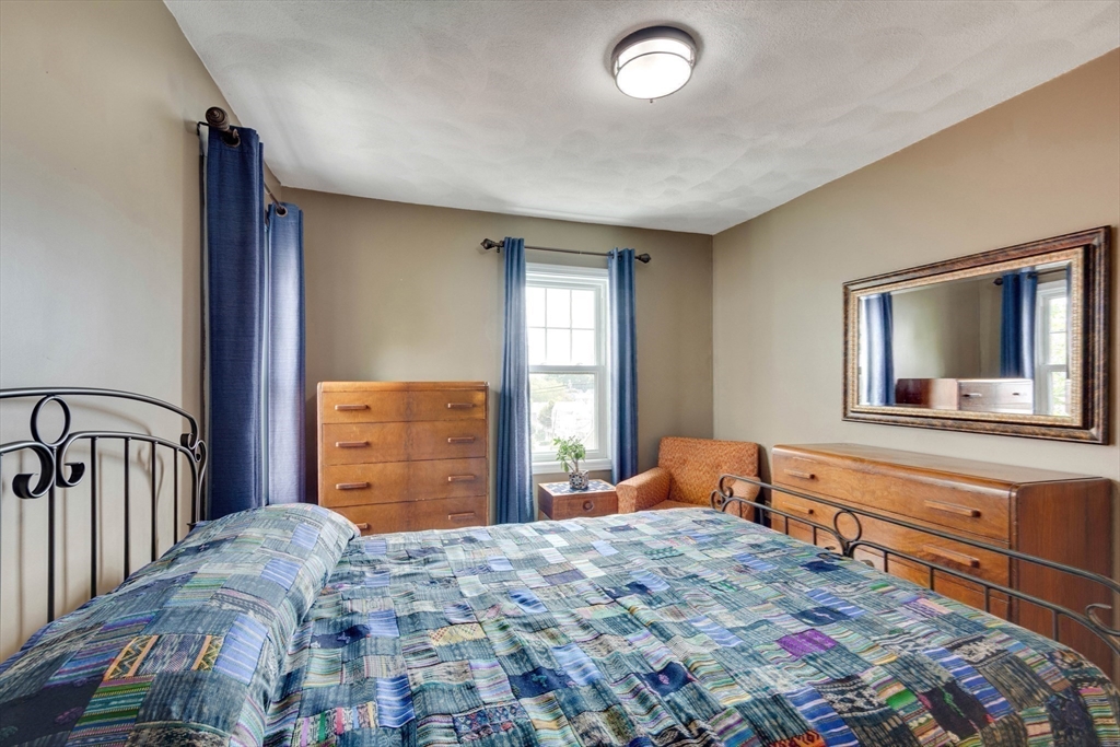 2 Deane Avenue Winthrop, MA 02152 - Photo 23 of 42 a bedroom with a bed and dresser with mirror
