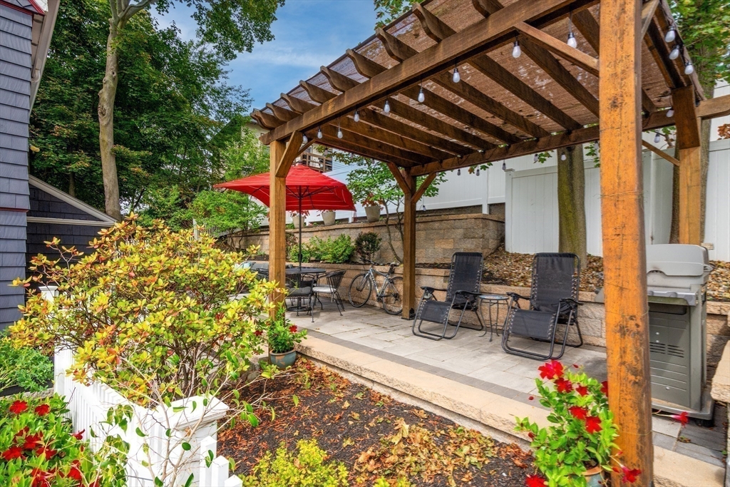 2 Deane Avenue Winthrop, MA 02152 - Photo 31 of 42 a view of patio with a table and chairs under an umbrella