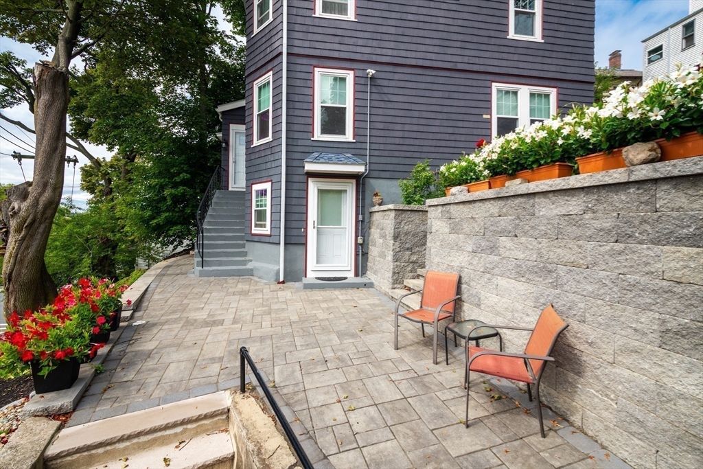 2 Deane Avenue Winthrop, MA 02152 - Photo 4 of 42 a wooden bench sitting in front of a house