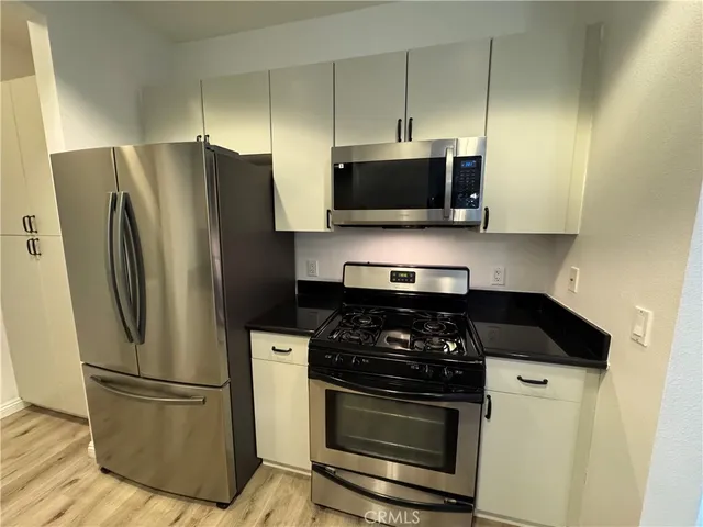 a kitchen with a refrigerator stove and microwave