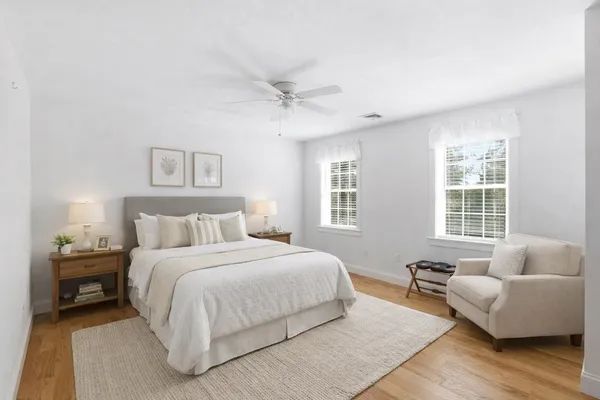a bedroom with bed couch and window