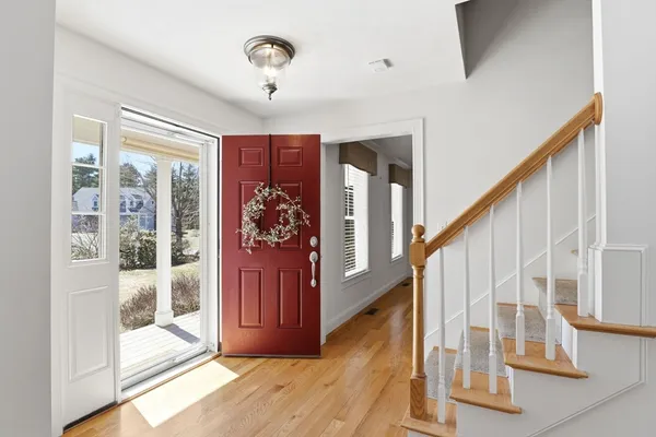 a view of entryway with wooden floor and windows