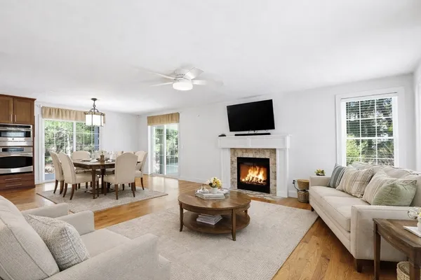 a living room with furniture fireplace and window