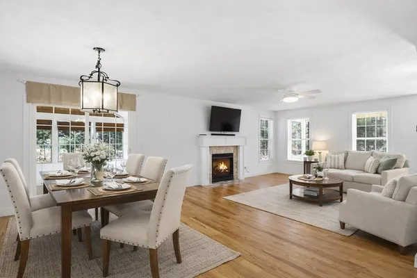 a living room with furniture a fireplace and a chandelier