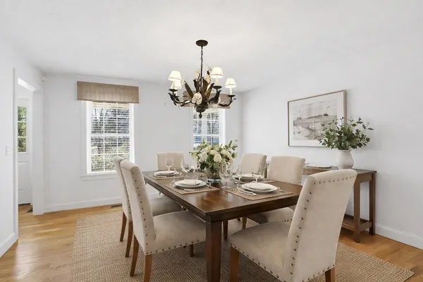 a view of a dining room with furniture wooden floor and a chandelier