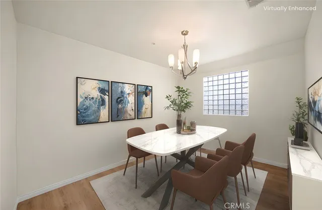 a view of a dining room with furniture wooden floor and a chandelier