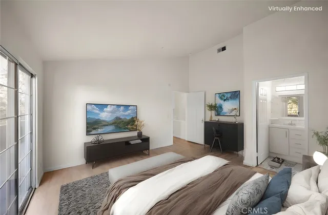 a bedroom with a bed and a television