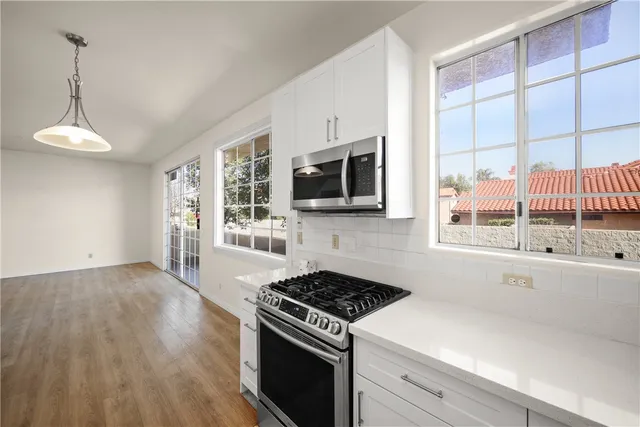 a kitchen with a stove a sink and a microwave