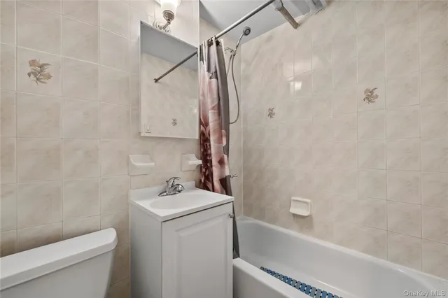a bathroom with a toilet sink and shower