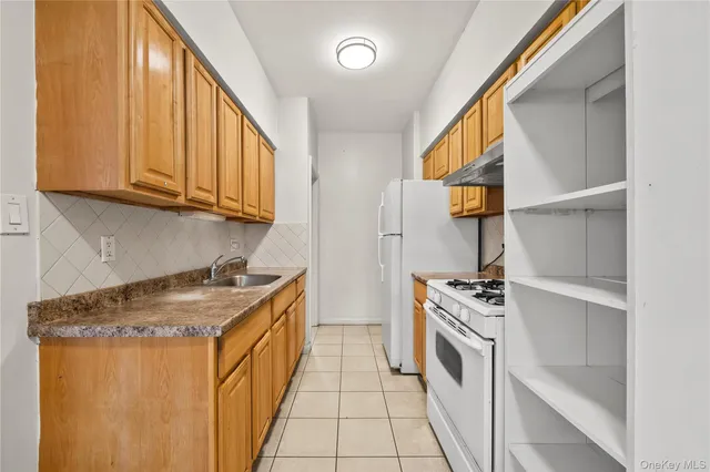 a view of a kitchen with a sink and dishwasher wooden floor