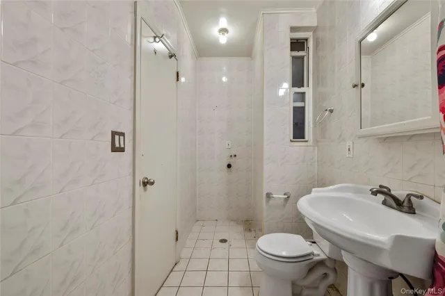 a bathroom with a glass shower door and two glass windows