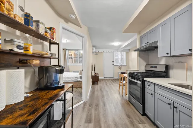 a large kitchen with a sink stainless steel appliances and cabinets