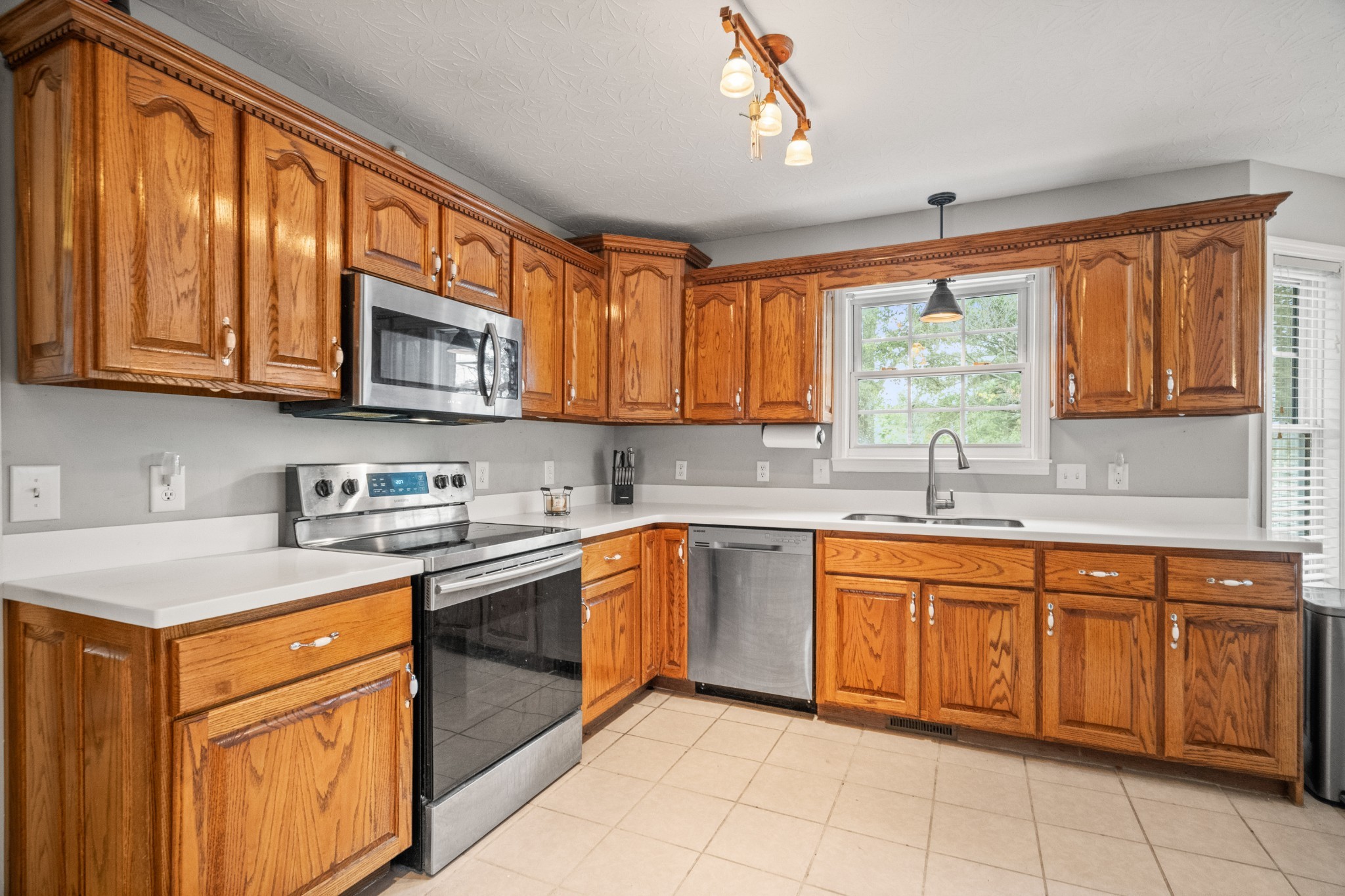 116 Old Parkers Chapel Road Portland, TN 37148 - Photo 29 of 64 a kitchen with stainless steel appliances granite countertop a stove sink microwave and window