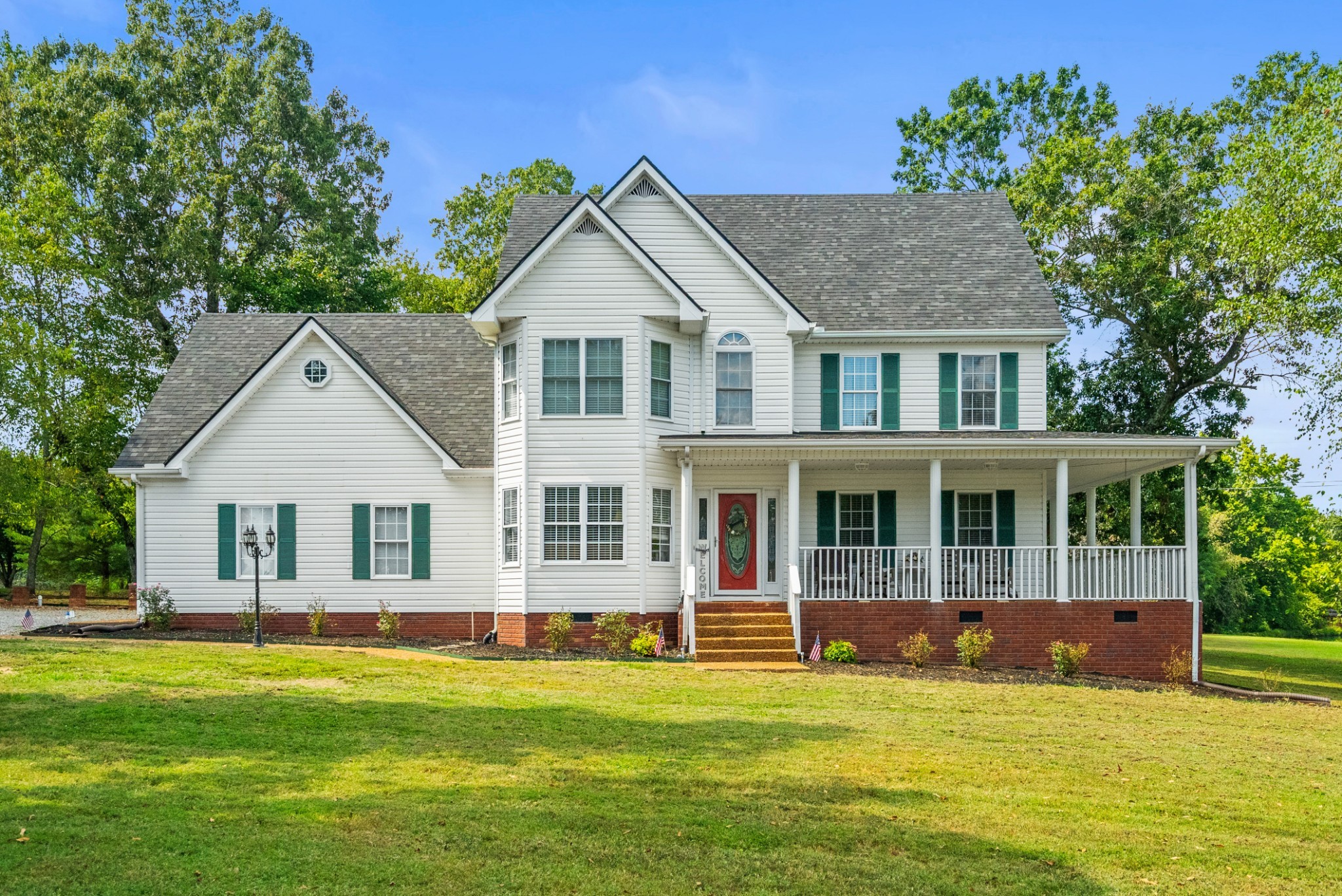116 Old Parkers Chapel Road Portland, TN 37148 - Photo 3 of 64 a front view of a house with a yard table and chairs
