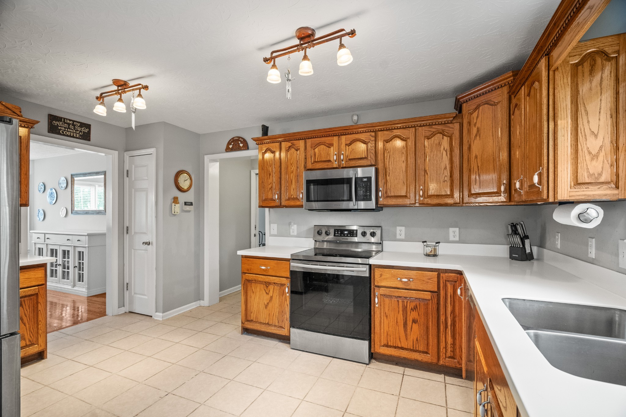 116 Old Parkers Chapel Road Portland, TN 37148 - Photo 31 of 64 a kitchen with stainless steel appliances granite countertop a sink dishwasher stove top oven and cabinets