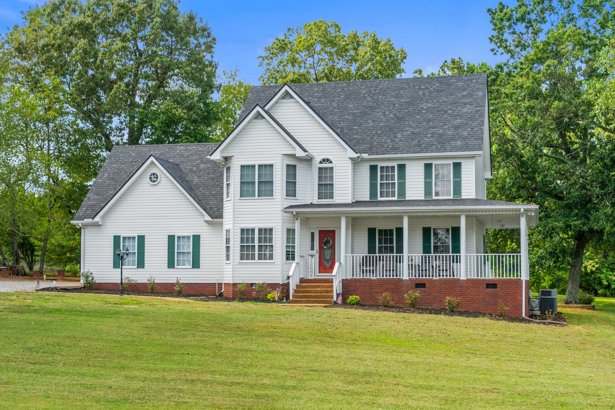 116 Old Parkers Chapel Road Portland, TN 37148 - Photo 7 of 64 a front view of a house with a garden and swimming pool