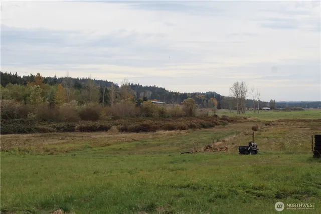 a view of a chairs and table in the back yard of the house