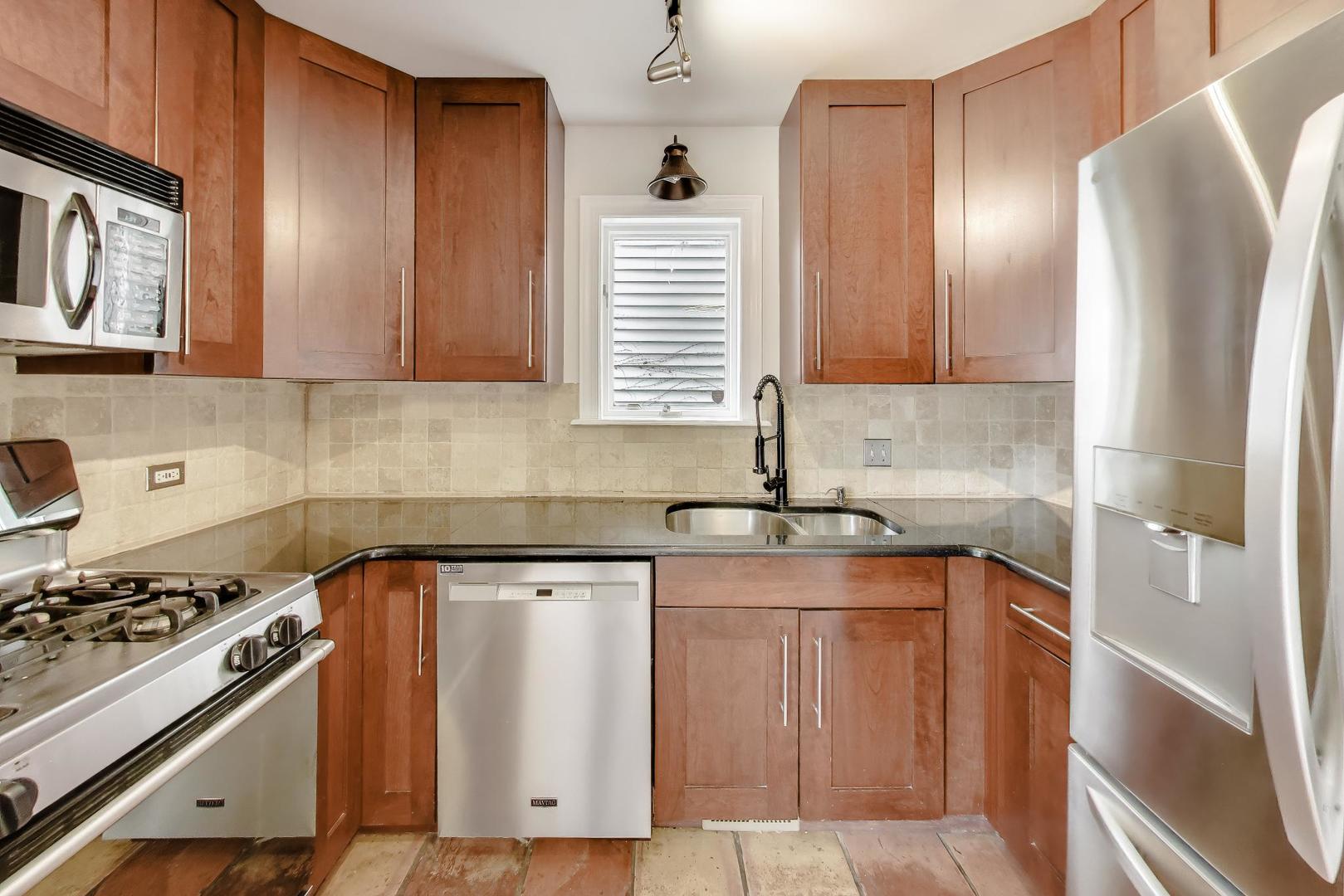 3413 South Indiana Avenue Chicago, IL 60616 - Photo 6 of 15 a kitchen with stainless steel appliances granite countertop a sink stove and refrigerator