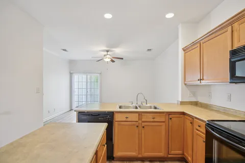 a kitchen with a sink stove and cabinets