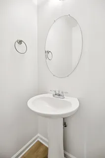 a bathroom with a sink a light fixture and a mirror
