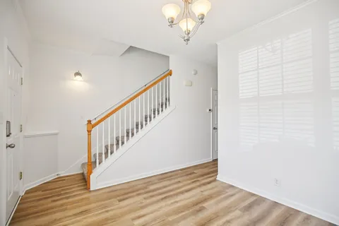a view of an entryway with wooden floor