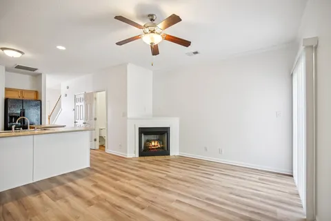 a view of a kitchen with a sink and a fireplace