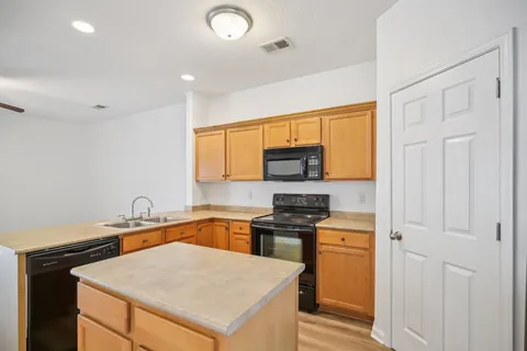 a kitchen with stainless steel appliances a stove sink and microwave