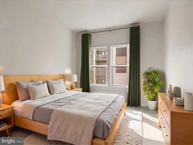 a bedroom with a bed and a potted plant