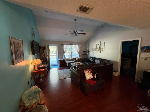 a living room with furniture flat screen tv and a fireplace