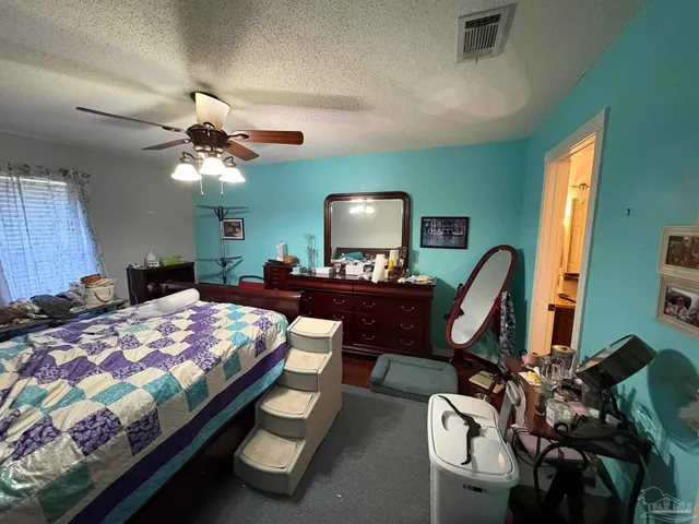 a bed room with furniture and a flat screen tv