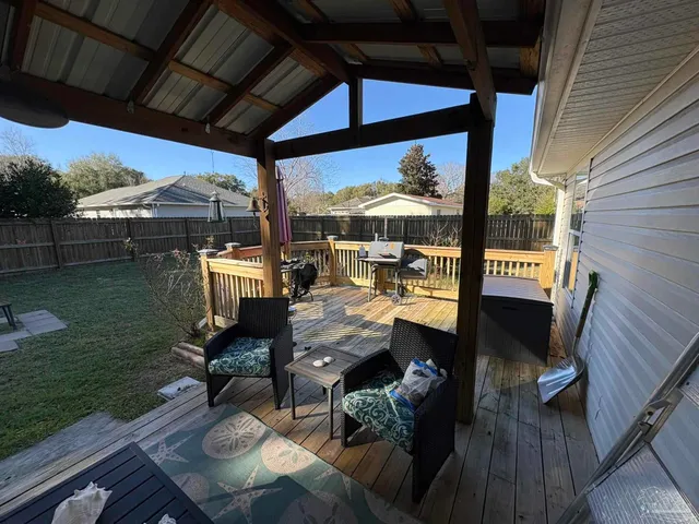 a view of a patio with table and chairs potted plants with wooden floor