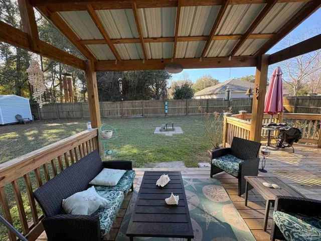 a view of a patio with couches chairs and a table with garden view