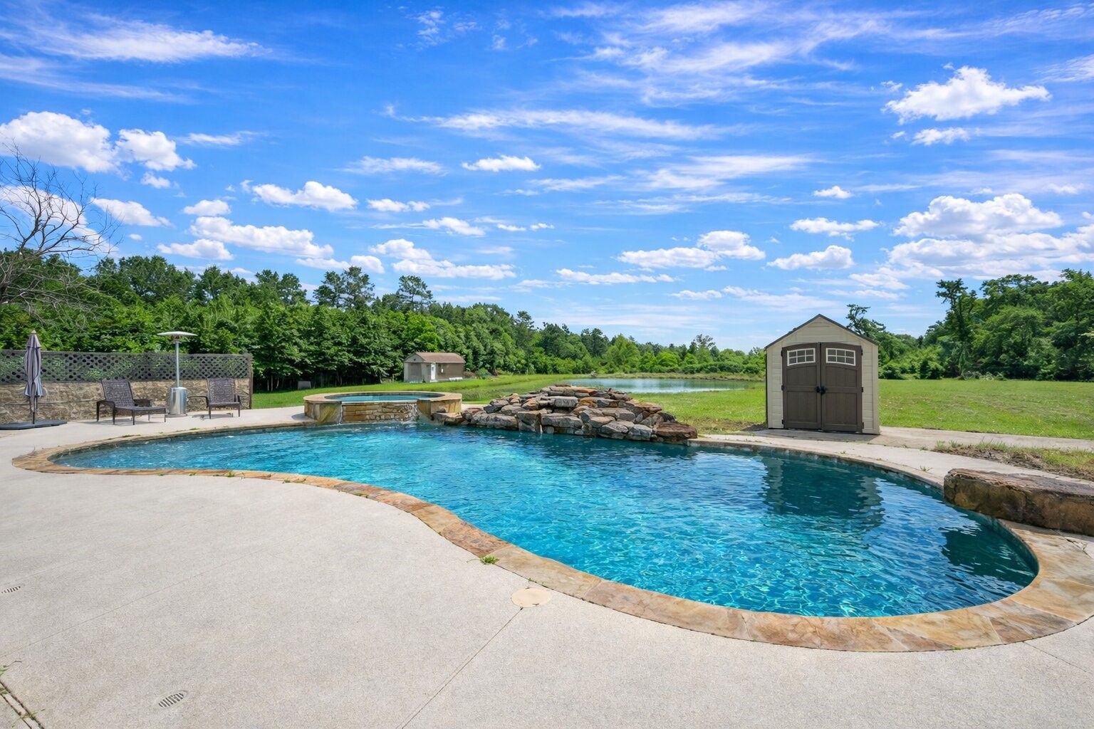 144 Wood Farm Road Huntsville, TX 77320 - Photo 29 of 35 a view of a swimming pool with a yard and a fire pit