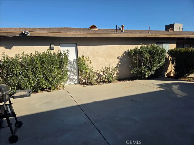 a view of house with a backyard and plants