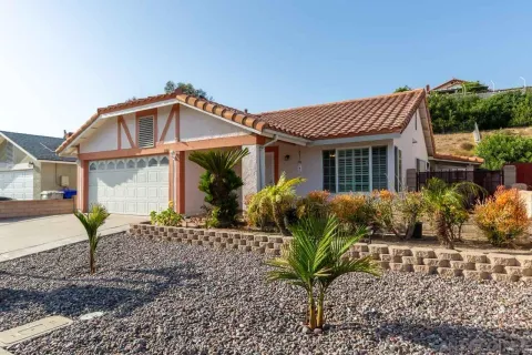 a front view of a house with a garden