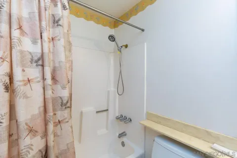 a bathroom with a shower and a shower