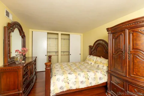 a bedroom with a bed next to a window