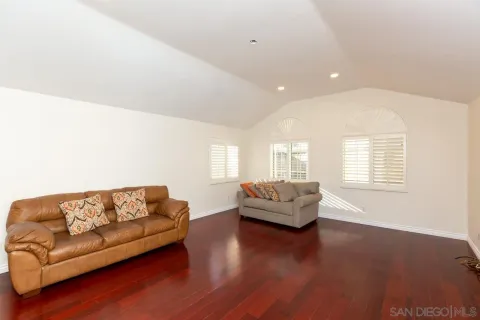 a living room with furniture and windows