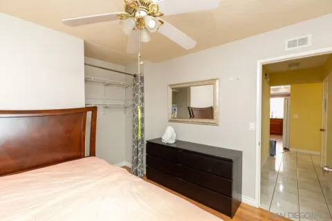 a bedroom with a bed and a mirror
