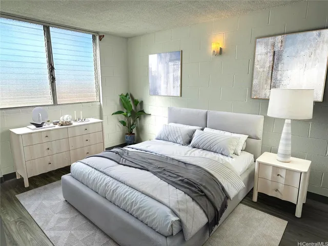 a spacious bedroom with a bed and a lamp