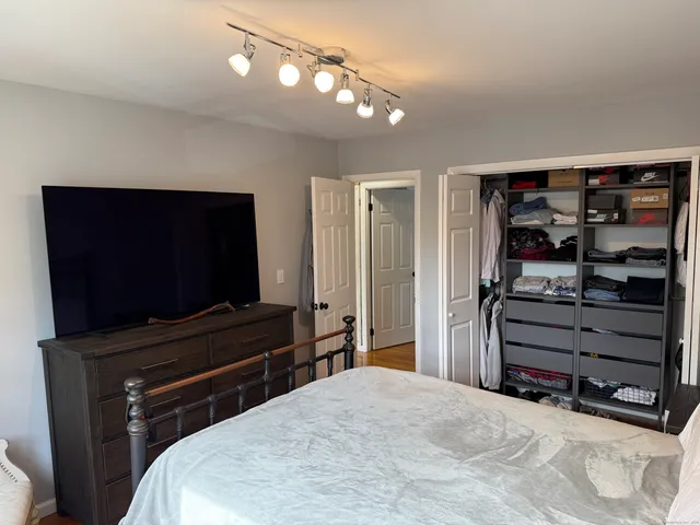 a bedroom with a bed and a television