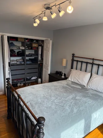 a bedroom with a bed and cabinets