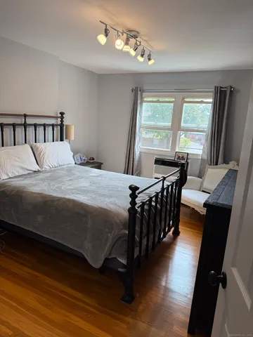 a bedroom with a bed and a table