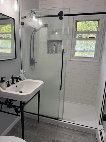 a bathroom with a sink a mirror and a shower