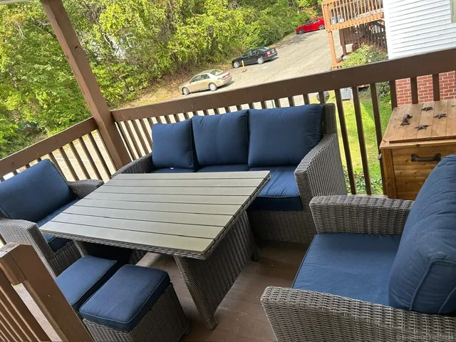 a balcony view with couple of furniture